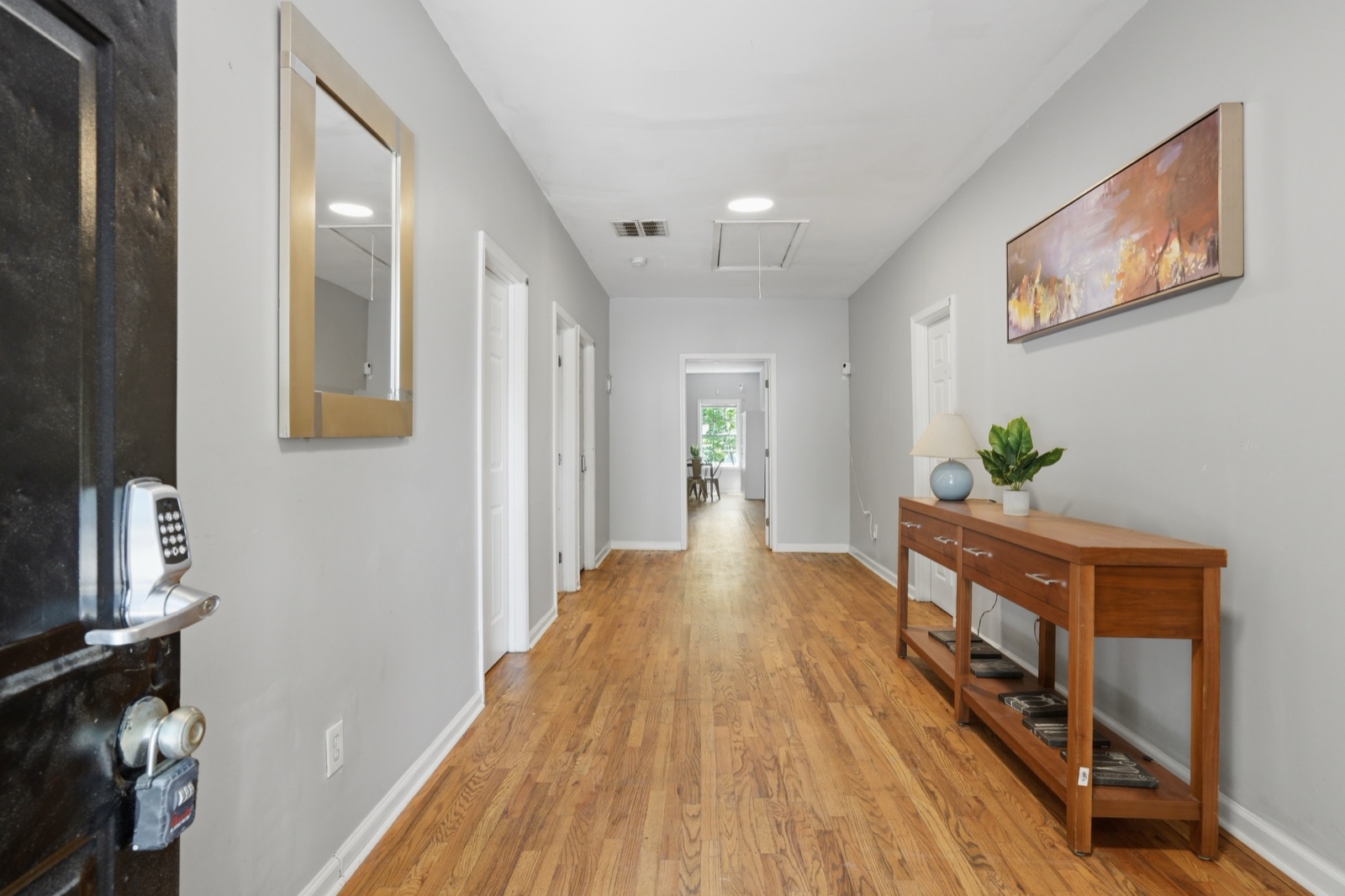 Wide central hallway with hardwood floors